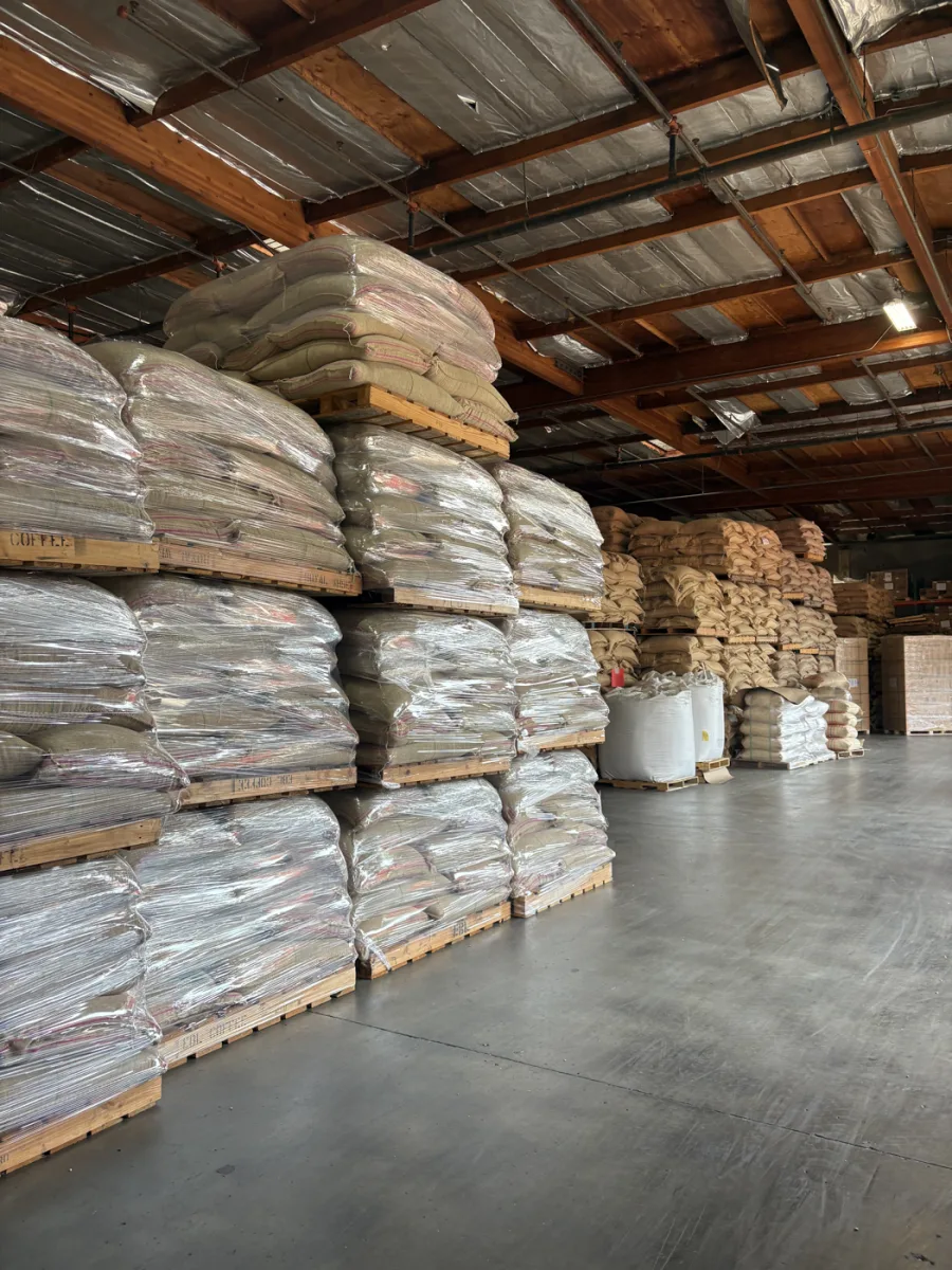 Green coffee stacked on pallets in the importer's warehouse